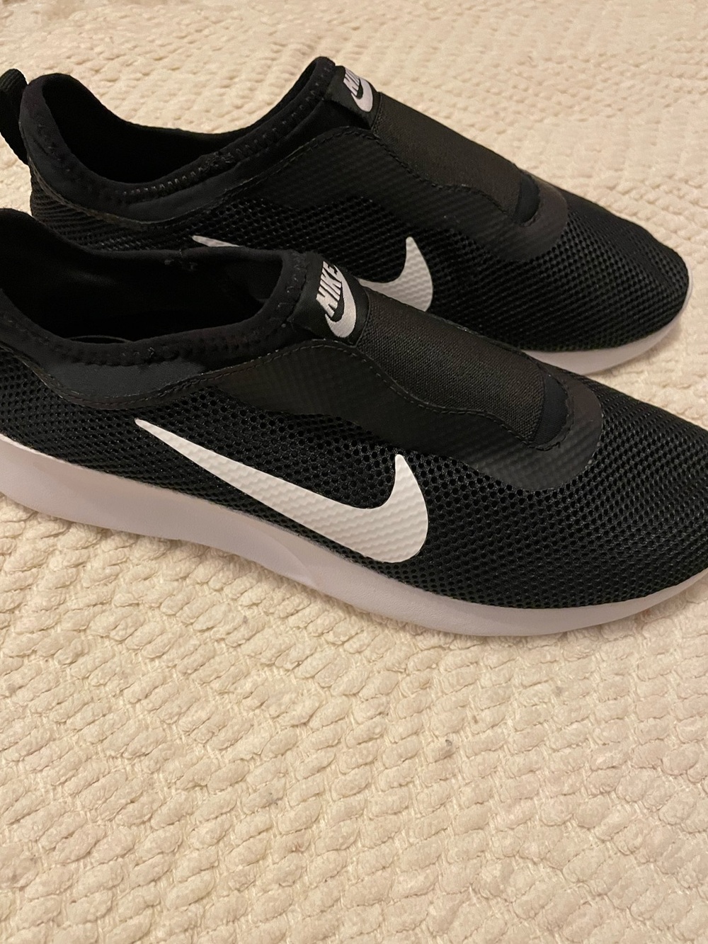 Nike Black Slip-On Sneakers with White Swoosh Accent